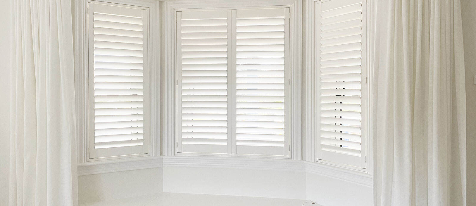 plantation shutters with sheer curtains